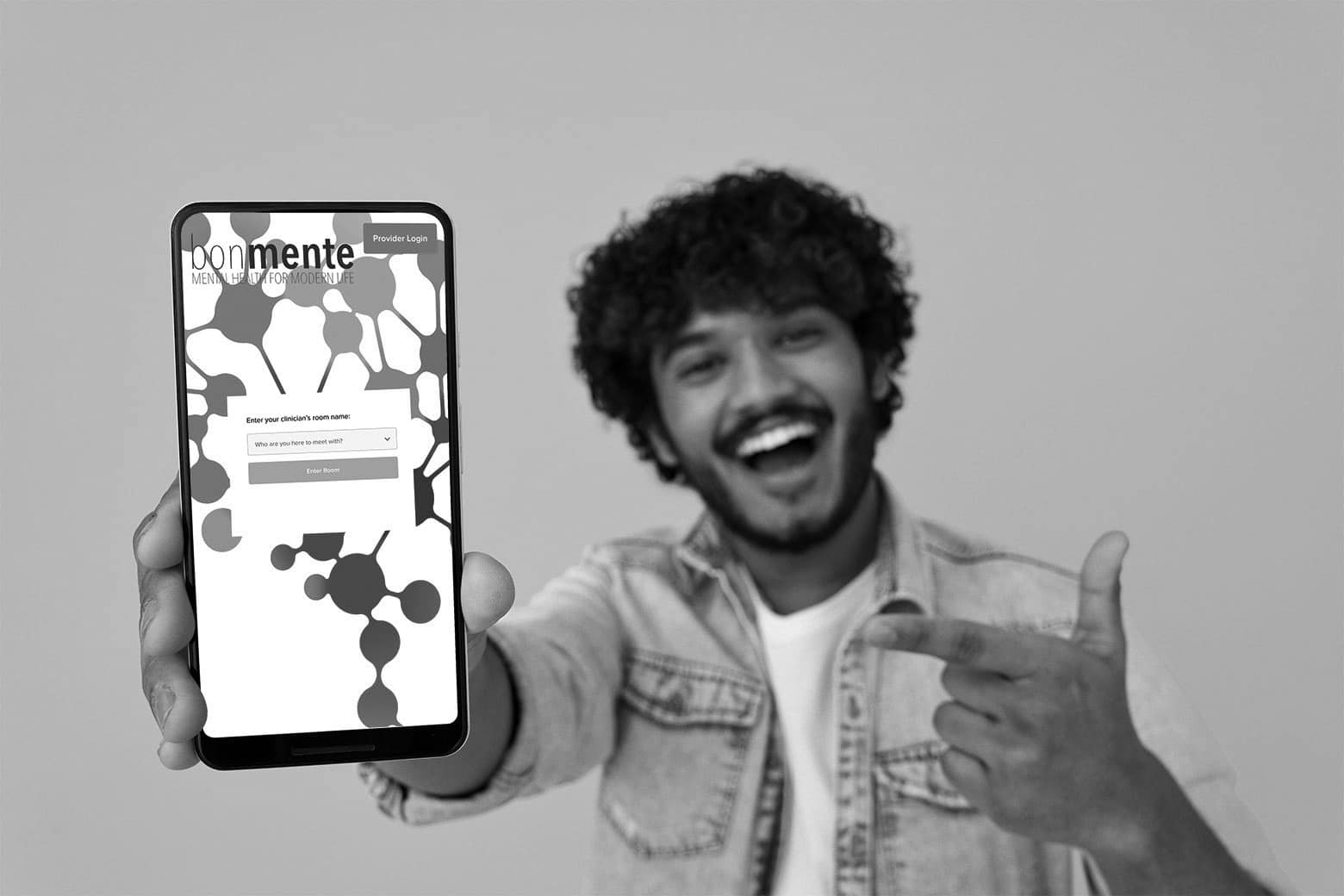 Man showing the bonmente mobile site on his phone, exploring therapy near me options and convenient access to mental health care